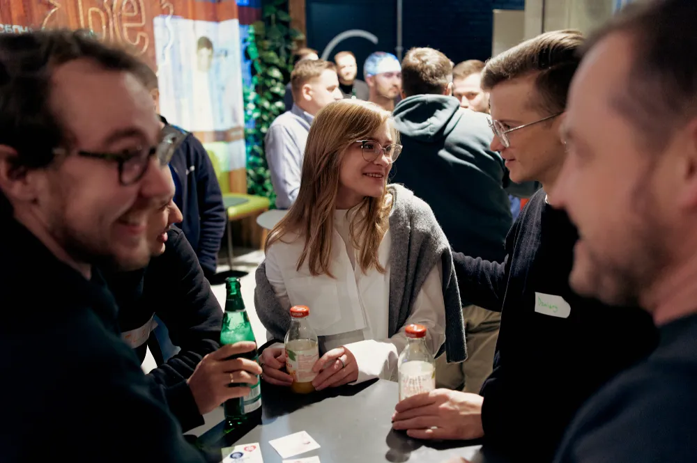 Guests talking over drinks at Inside game architecture