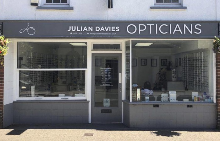 Storefront of Julian Davies Opticians with display windows and glasses