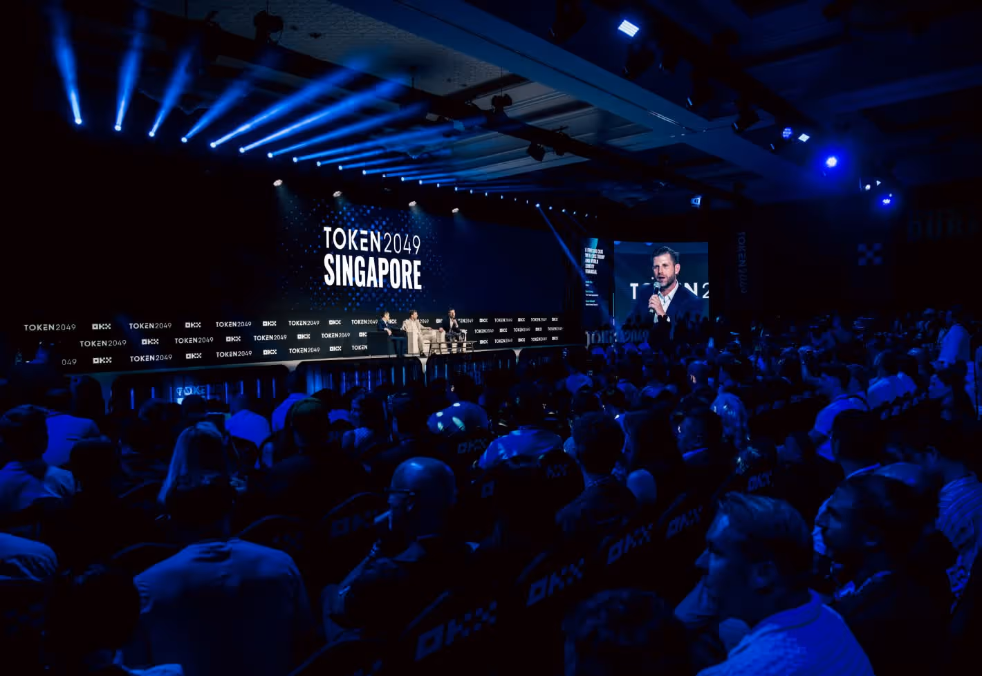 Token 2049 Singapore conference with blue-lit stage and packed audience