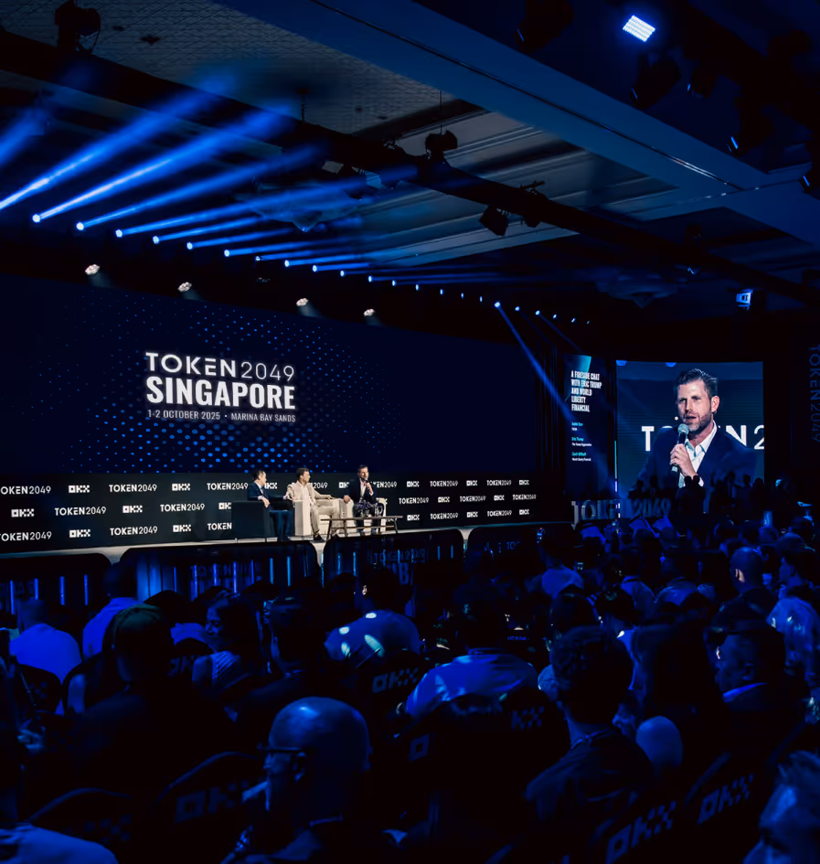 Token2049 conference in Singapore with blue lighting and packed audience