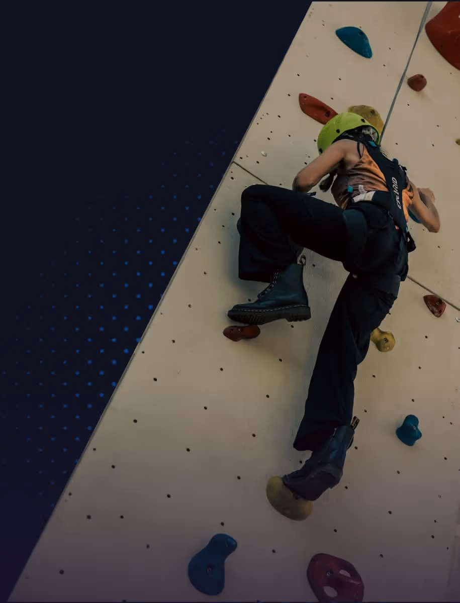 TOKEN2049 climber scaling colorful wall in Singapore indoor climbing gym