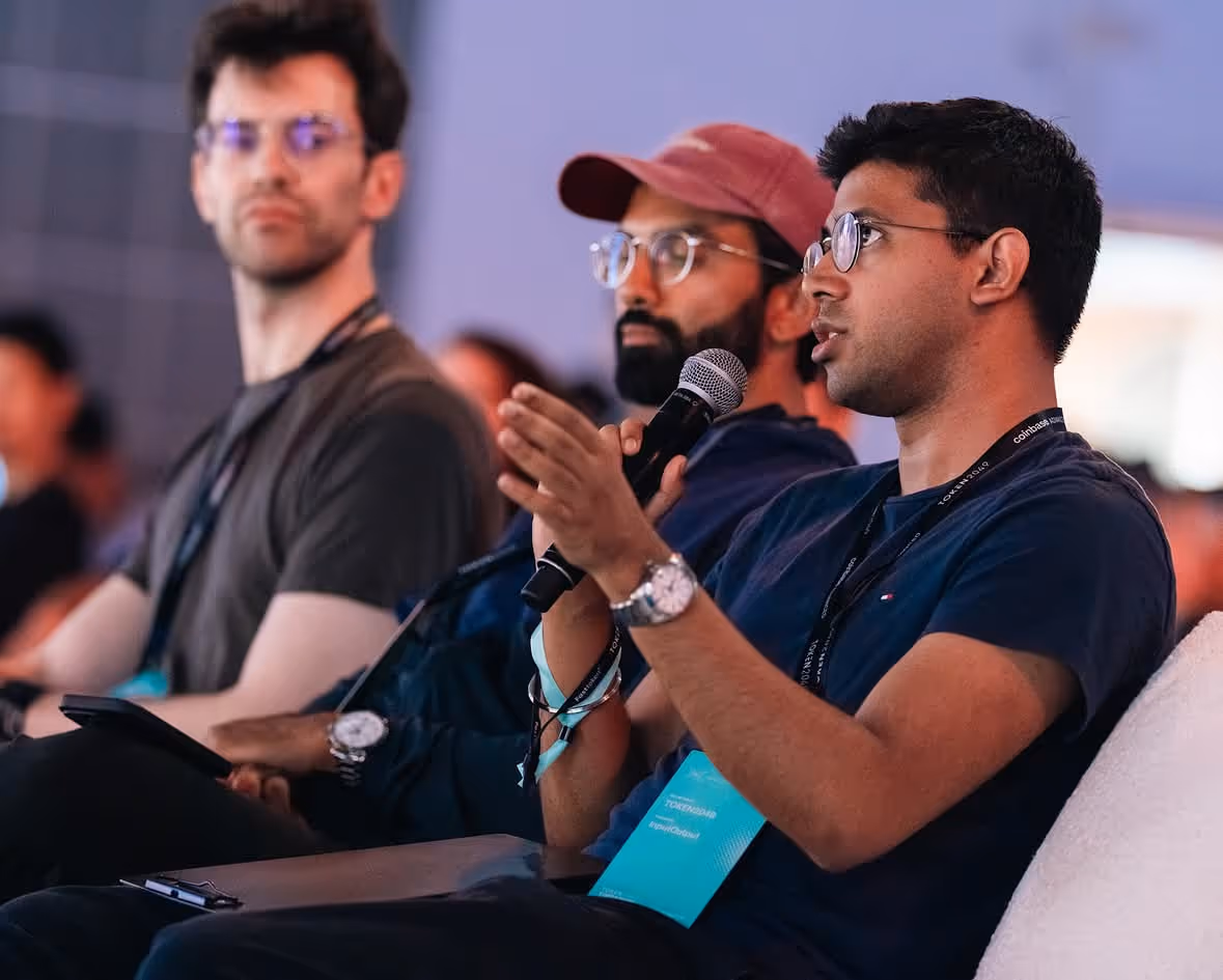 Attendees speaking at TOKEN2049 conference in Singapore, engaging in panel discussion