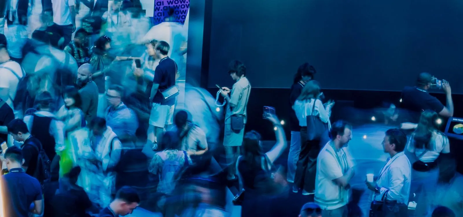 TOKEN2049 conference crowd networking in blue-tinted Dubai event space