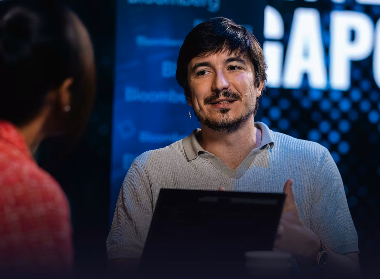 A man being interviewed on camera in front of a Bloomberg-branded backdrop at TOKEN2049 Singapore.