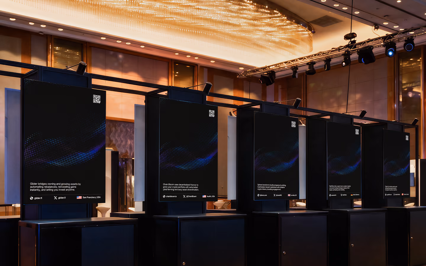 Five black digital display panels with QR codes and text in a modern conference room setting.
