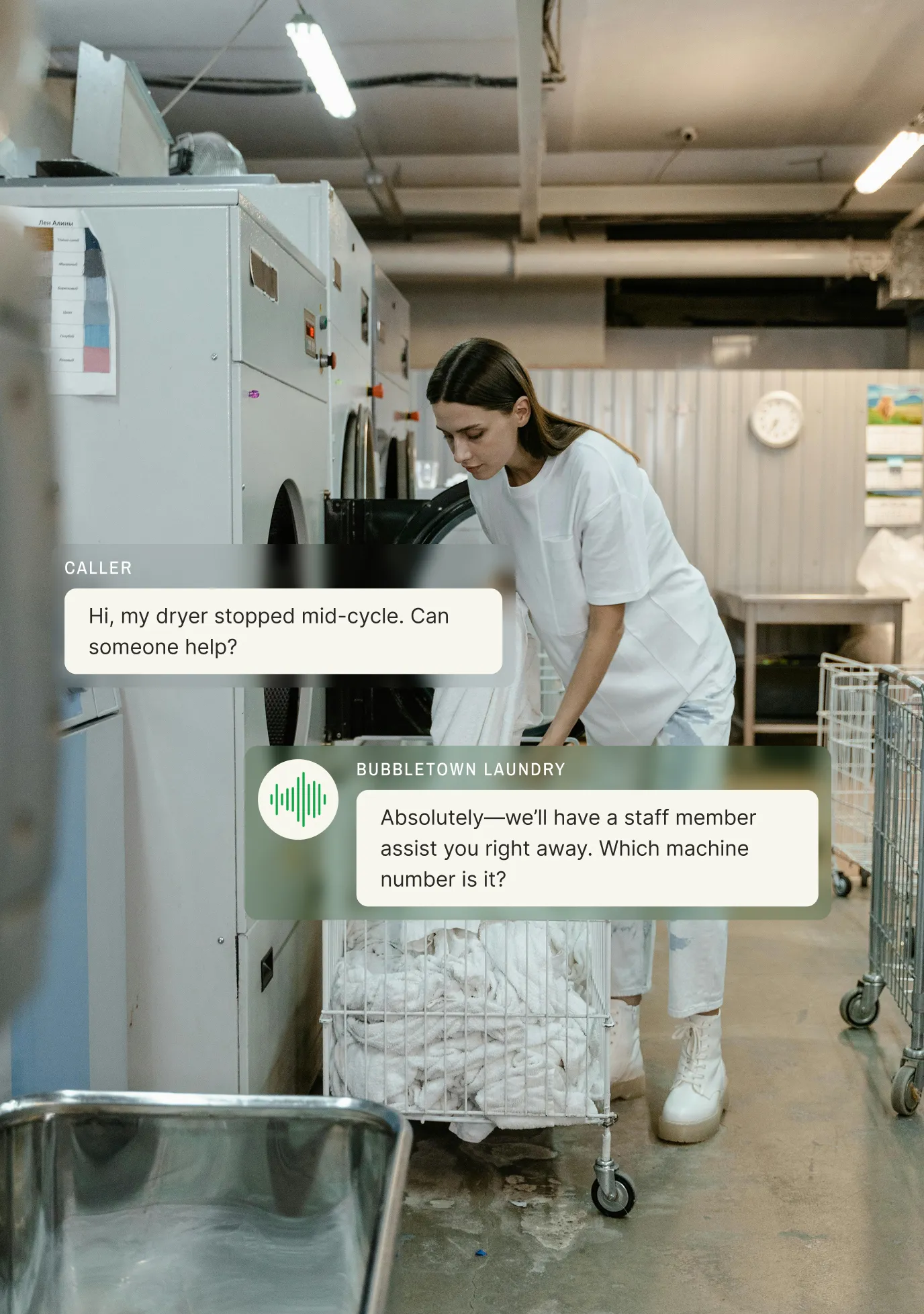 A laundromat attendant checks a dryer while a caller reports a mid-cycle stoppage and an answering service for laundry services asks for the machine number.