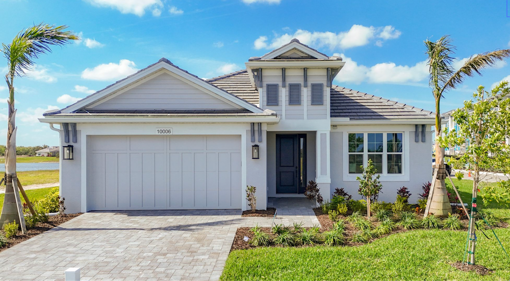 Exterior view of a hurricane-resistant Medallion home in Southwest Florida with landscaped lawns and bright sunny skies.