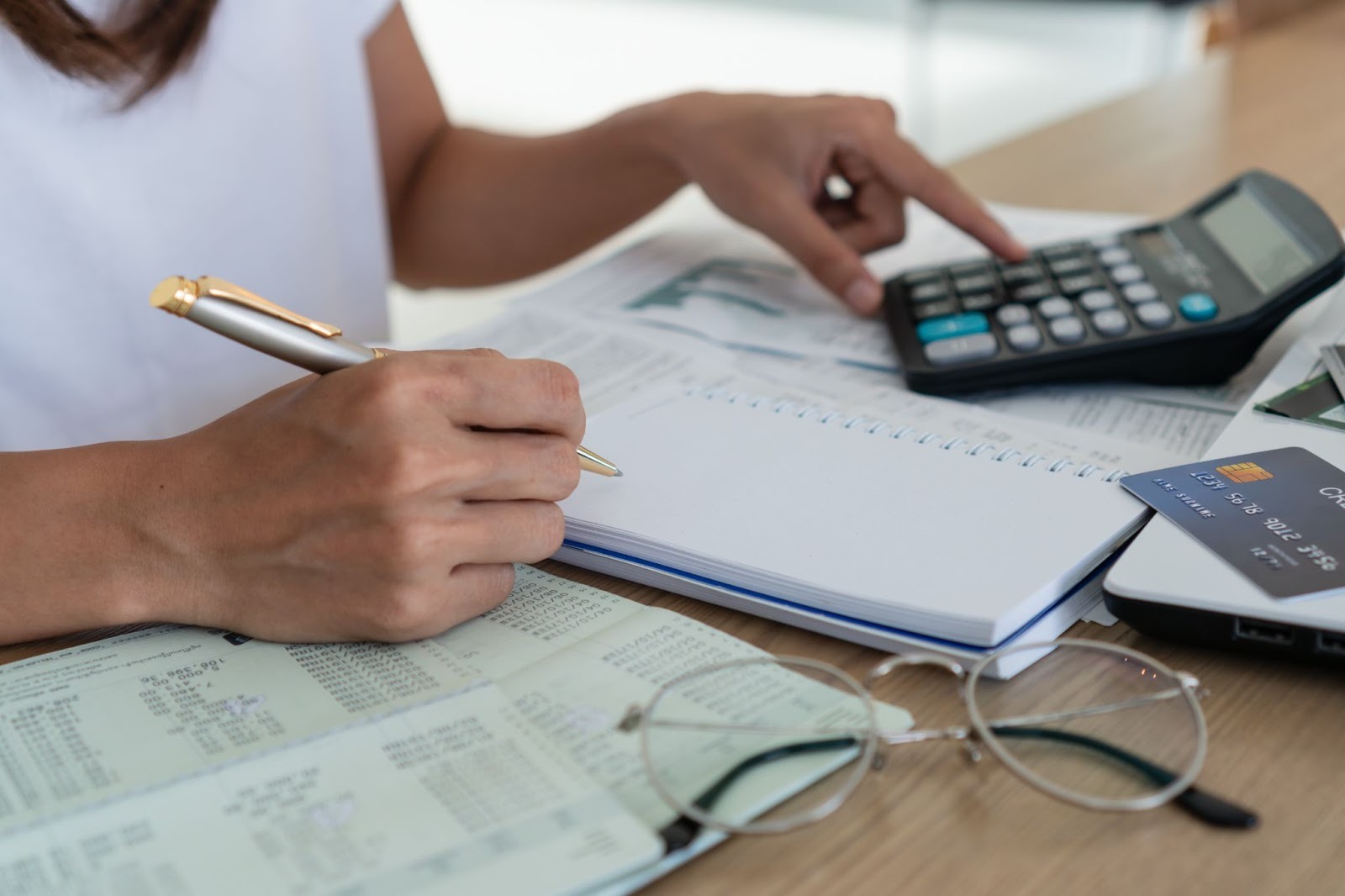 Woman sitting at desk paying bills