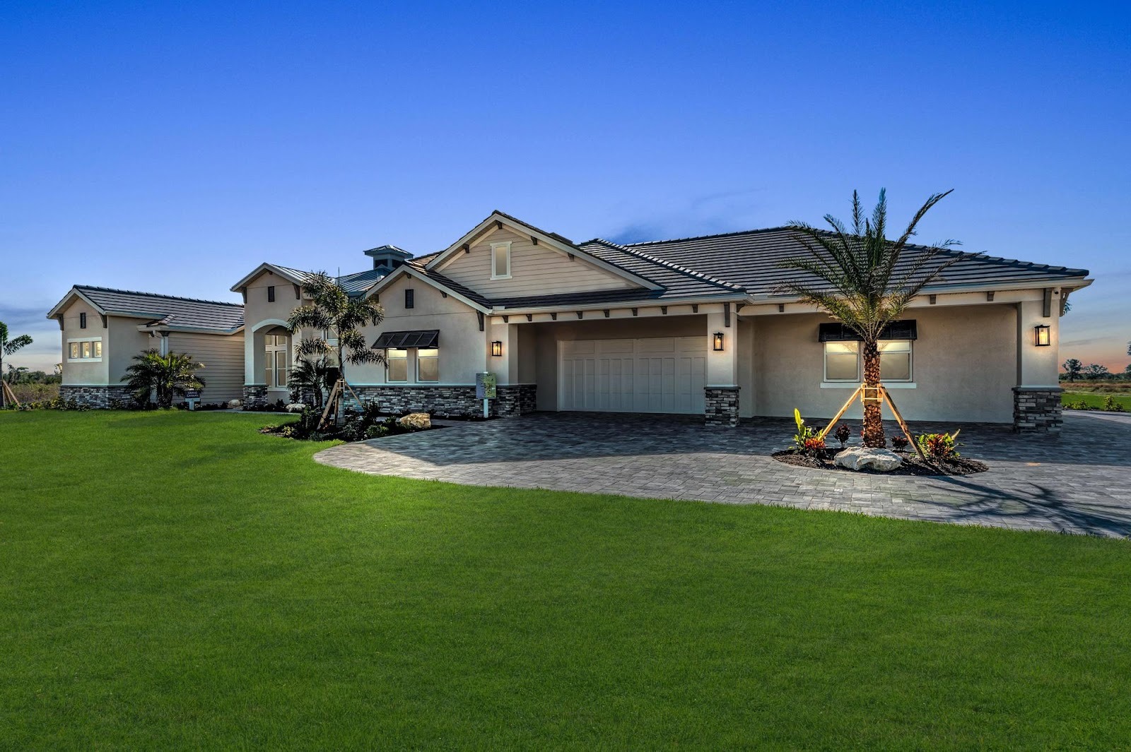 Exterior of the Grand Cayman home in the evening by Medallion Home