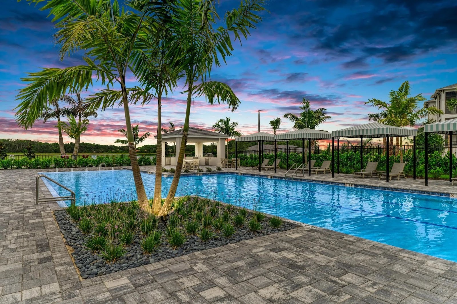 Pool and cabanas at Watercolor Place at dusk