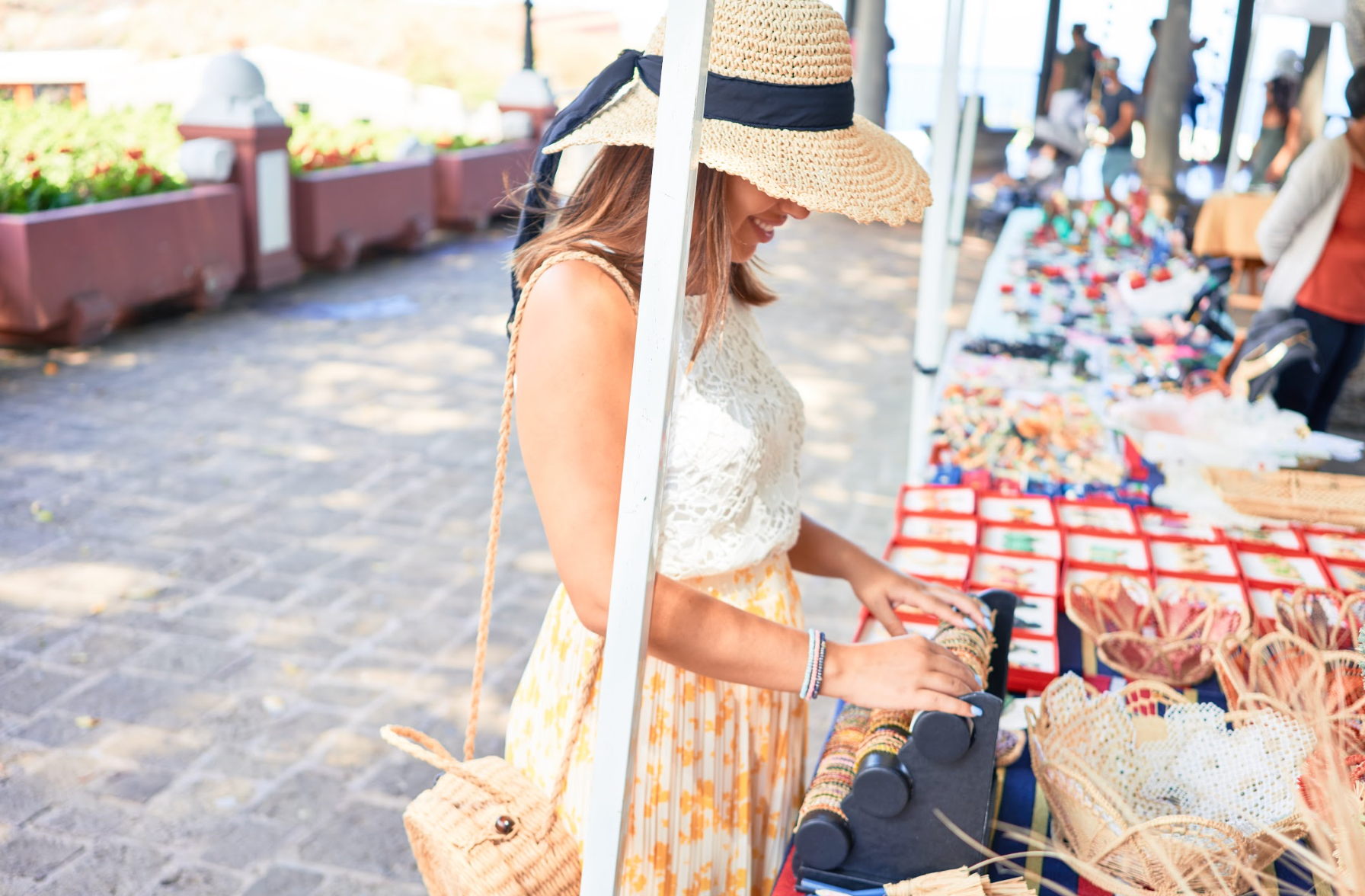Young woman shopping at an outdoor craft market.