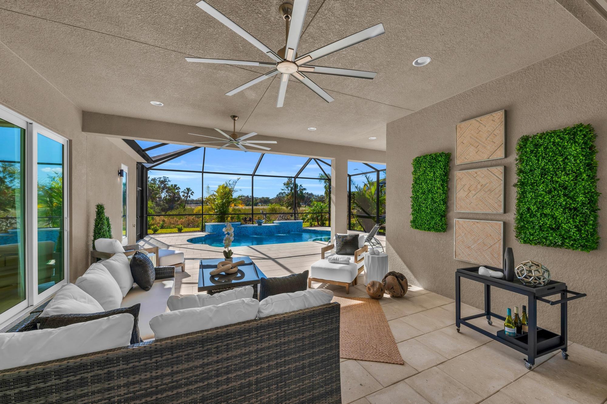 Medallion Home fully furnished pool and lanai during a sunny day
