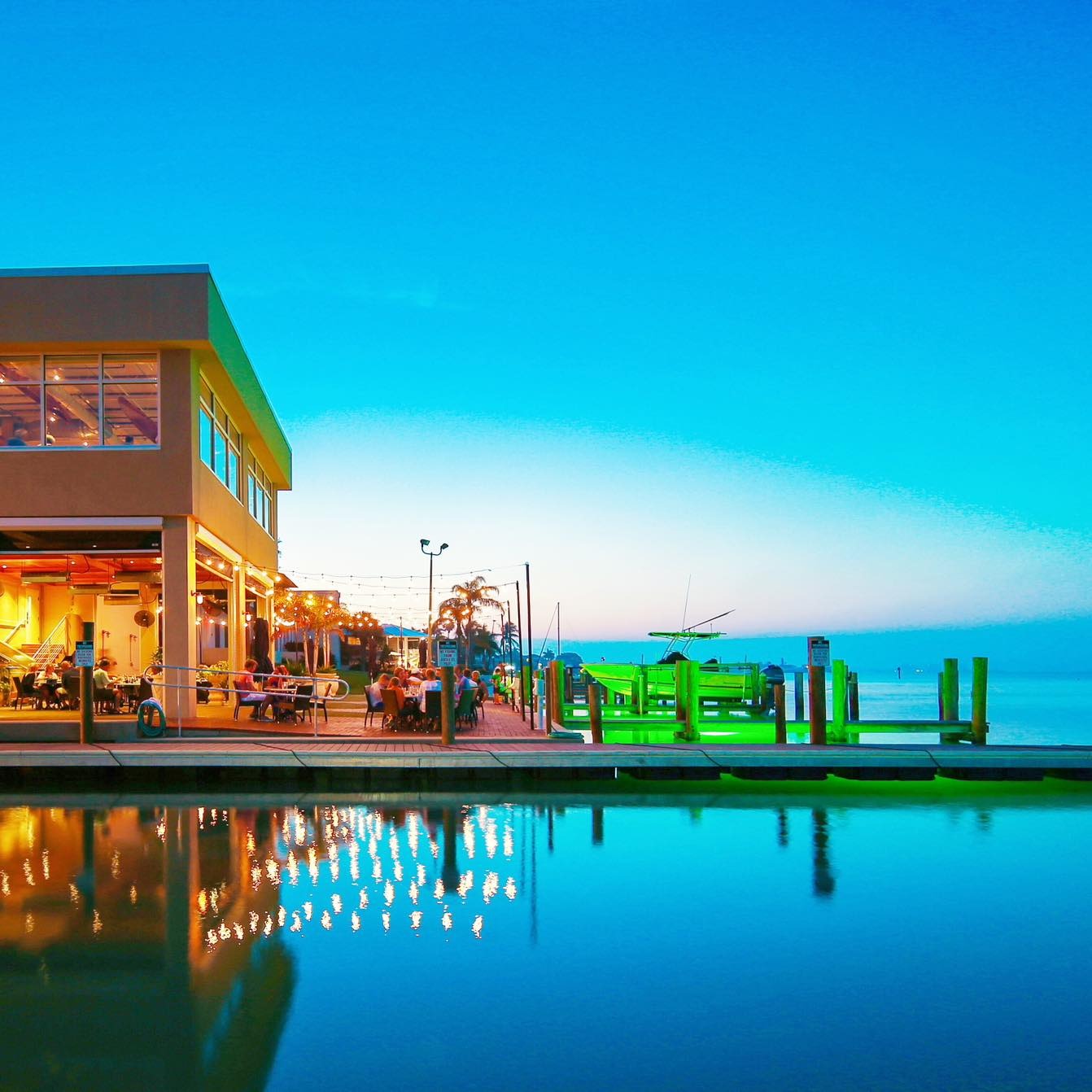Outdoor dining at Dry Dock Waterfront Grill at sunset CAPTION: Photo credit: Dry Dock Waterfront Grill