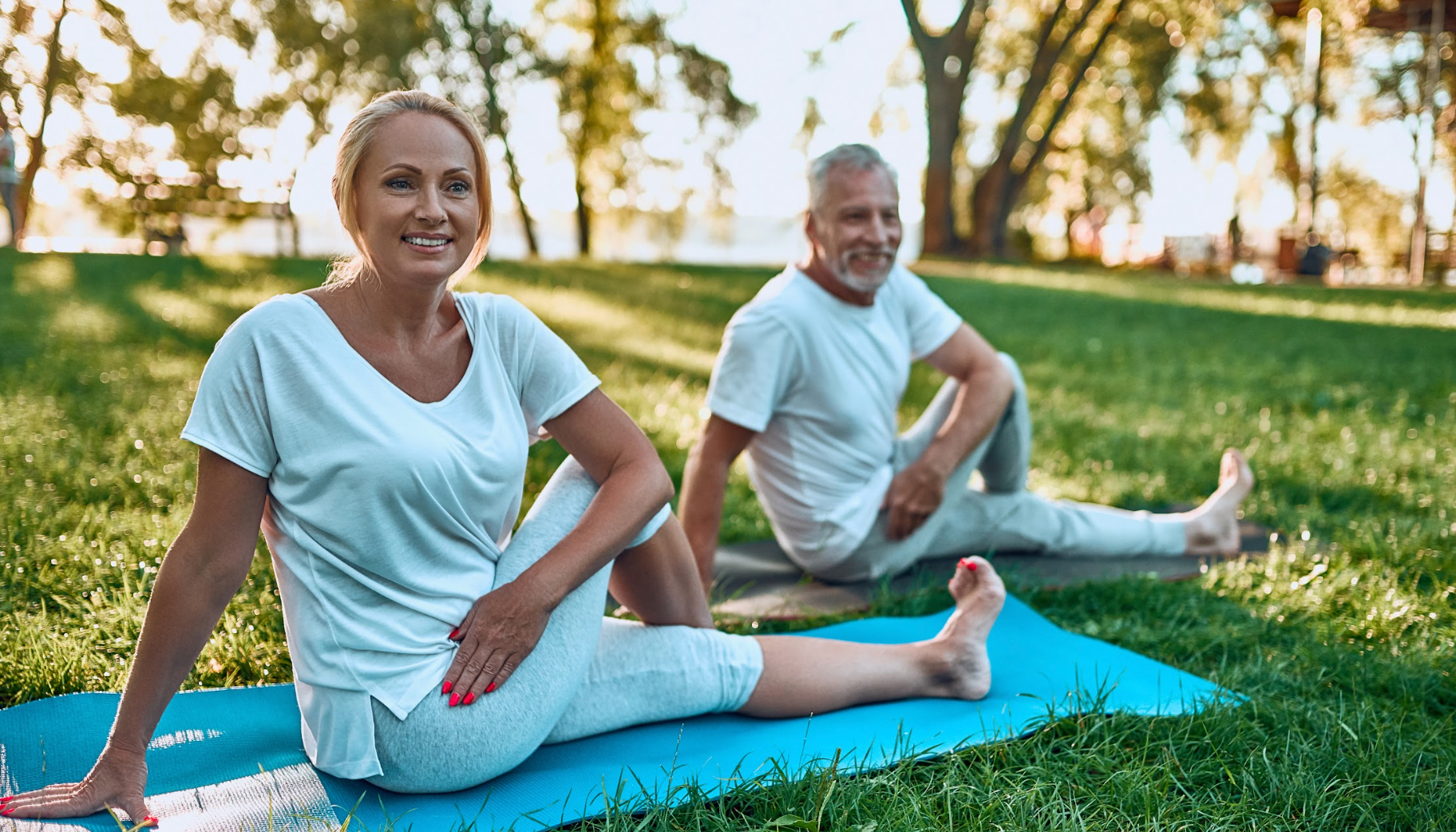 Mature couple stretching together outside