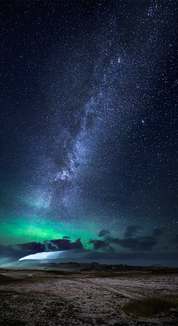 A view of the night sky with lots of stars and the northern lights