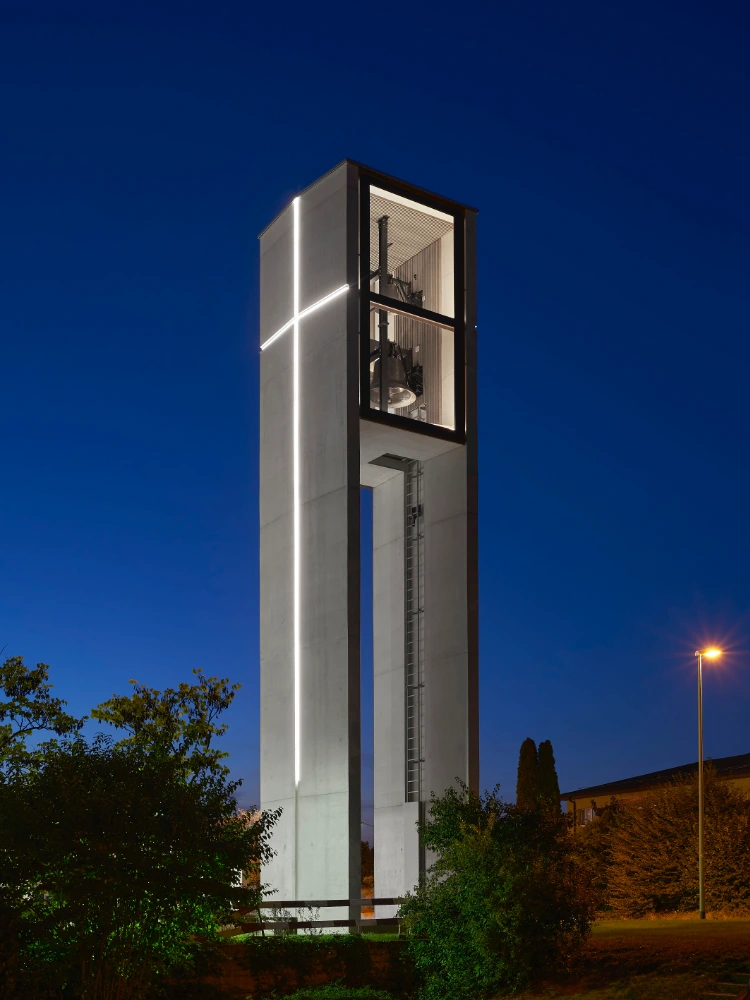 Night drone photograph of the illuminated church tower in Dietlikon designed by Meier Partner Architekten