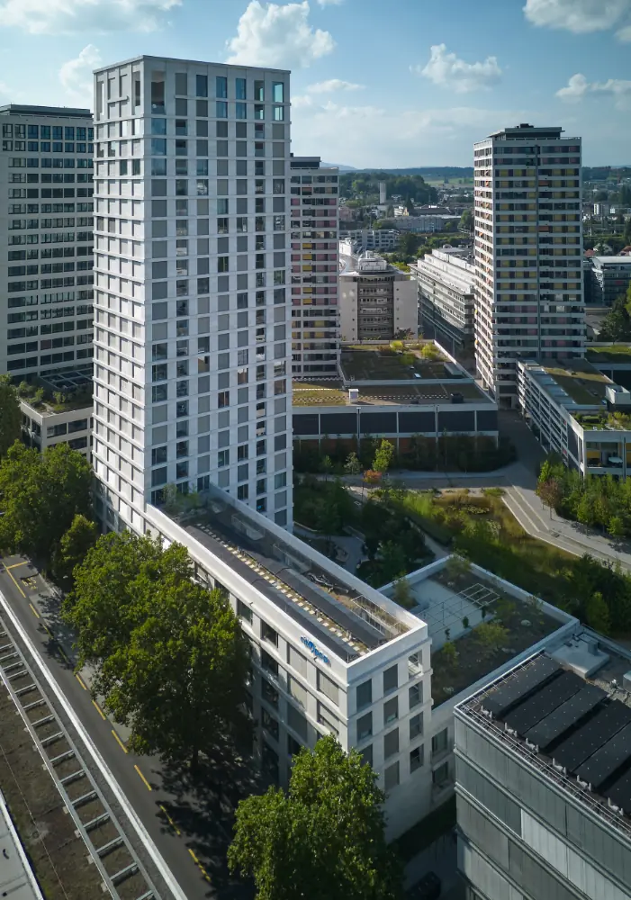 Night drone photograph of the illuminated church tower in Dietlikon designed by Meier Partner Architekten