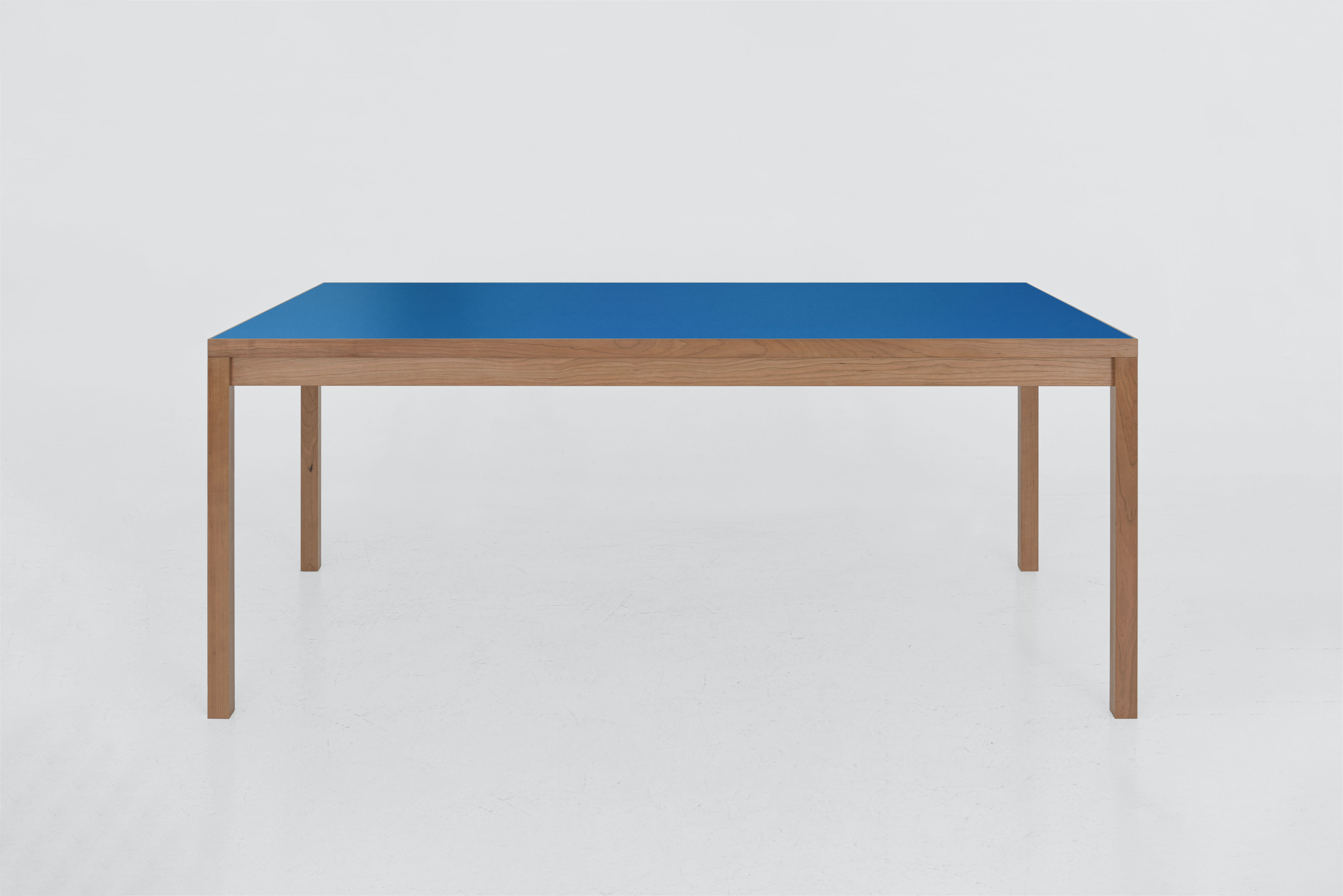 Our Large Table is characterized by its clean lines and classic proportions. Featuring premium cherry wood and a vibrant laminate top, it's a standout piece that works perfectly in both traditional and modern interiors. And it's as durable as it is striking—we designed the table to be ready for all occasions, whether you’re hosting a dinner party, working from home, or enjoying a quiet moment around the table. Seats eight. 