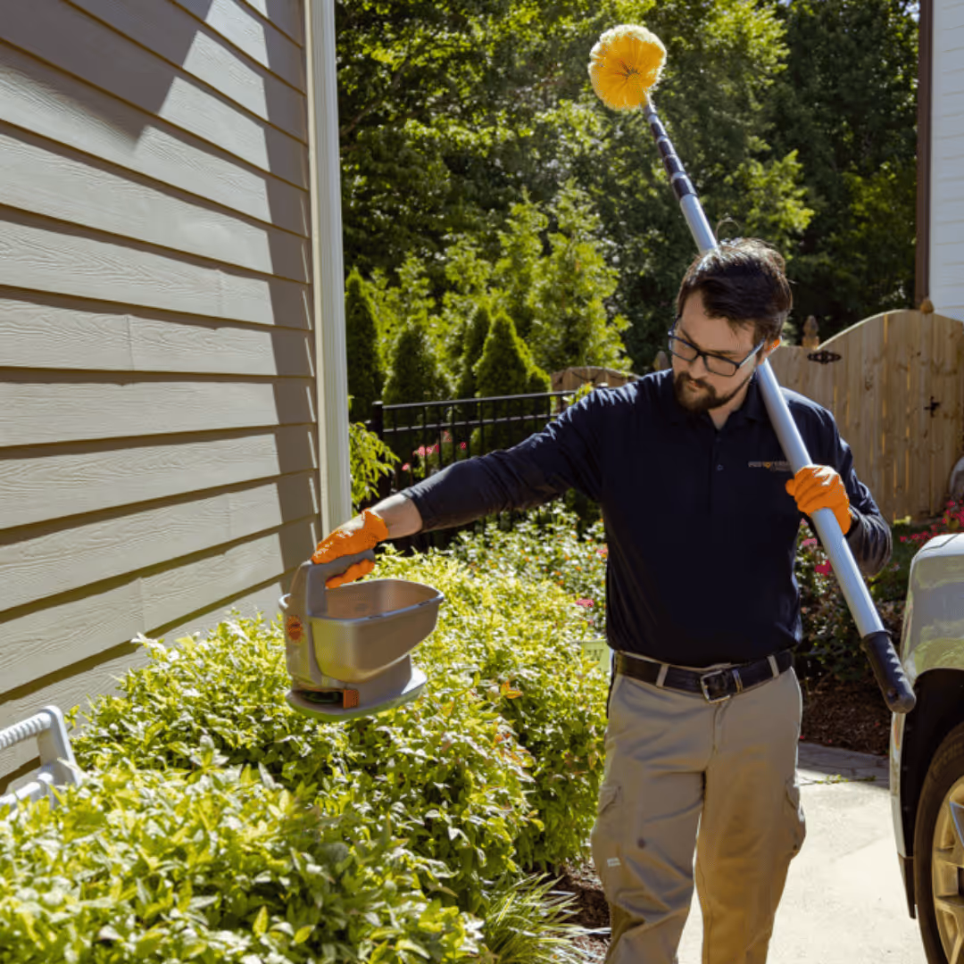 pest and termite consultants pest control technician treating a home in raleigh