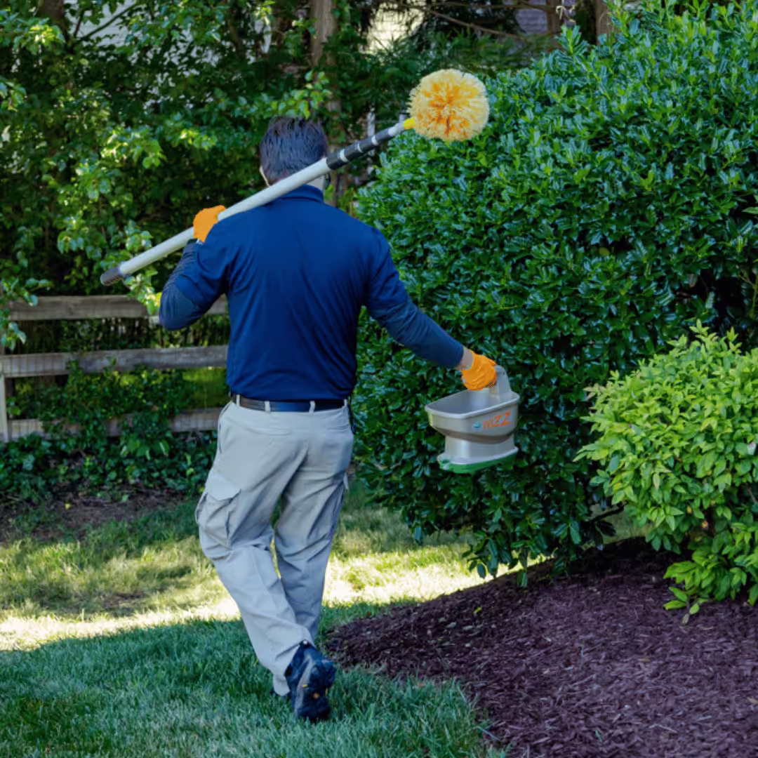 pest and termite technician performing pest control treatment in wilmington, nc