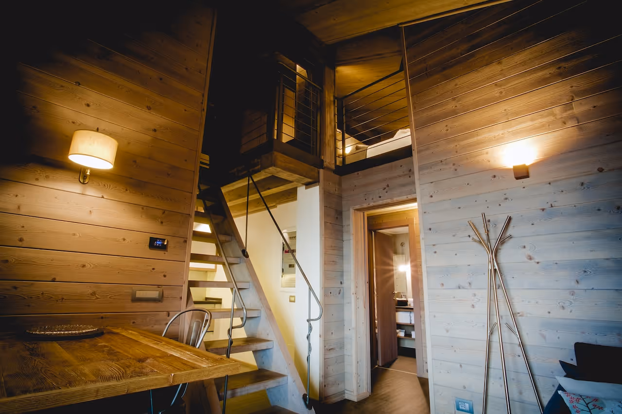 Upstairs cozy bedroom with wooden decor in the Loft Suite at La Cresta.