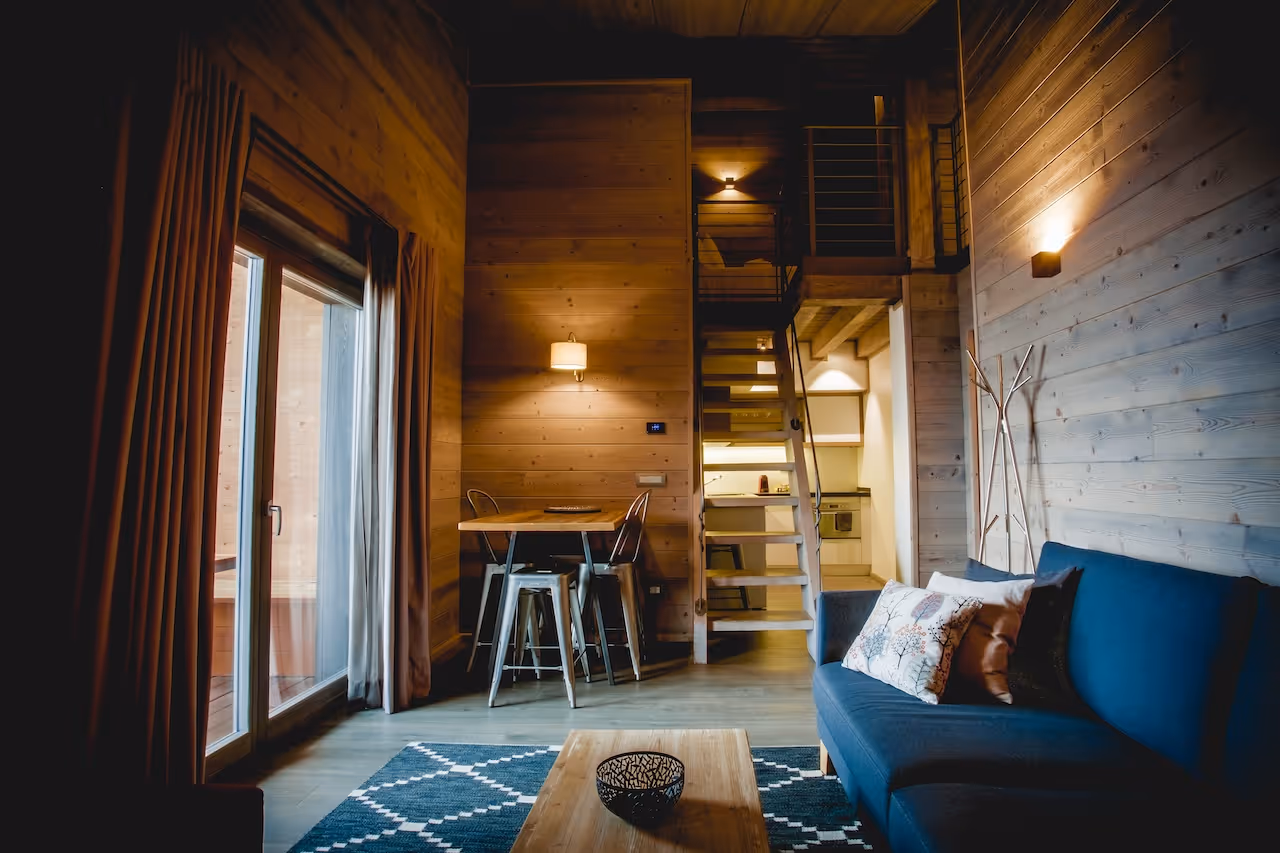 Spacious living area in the Loft Suite at La Cresta, featuring wooden interiors and large windows.