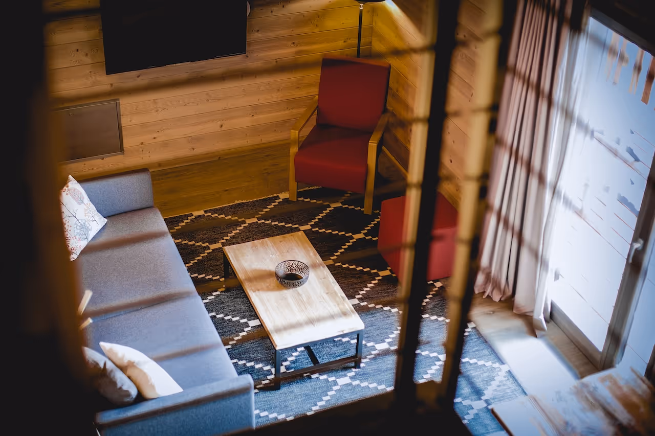 View of the Loft Suite living area from the stairs, showcasing a comfortable seating arrangement.
