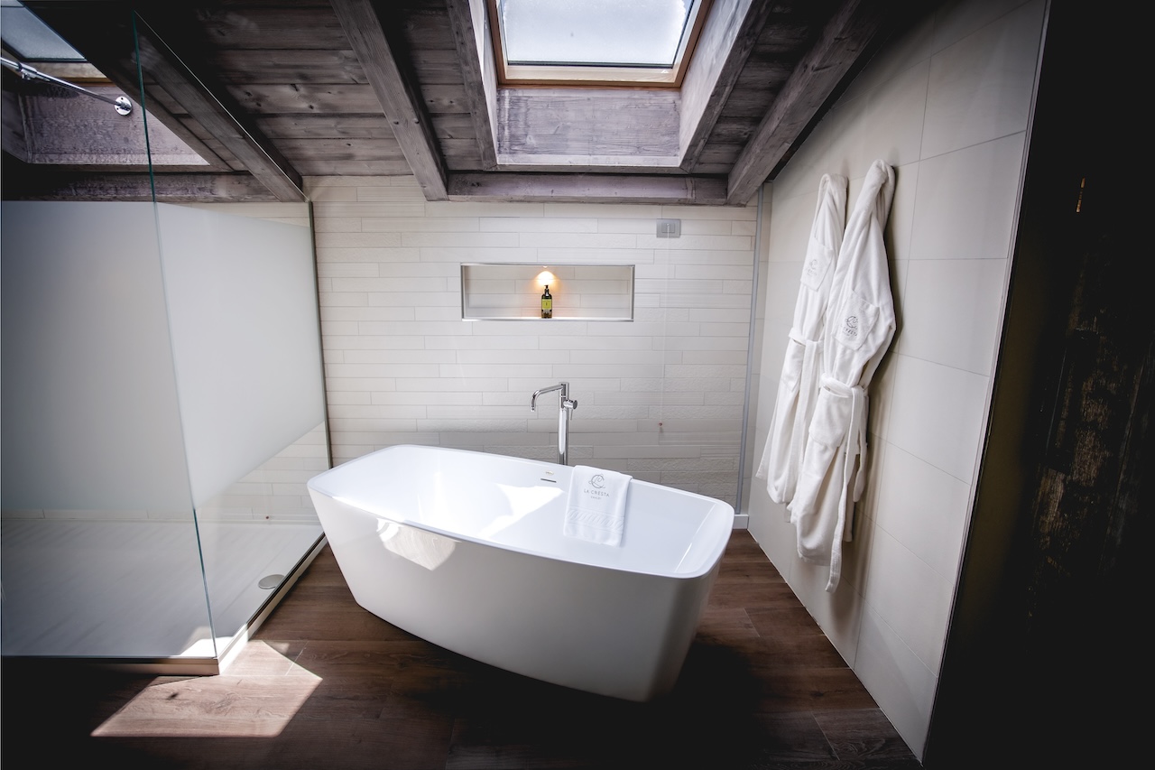 Luxurious freestanding bathtub under a skylight in the Retreat Suite bathroom at La Cresta Chalet.