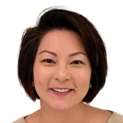 Smiling woman with short dark hair against a white background.