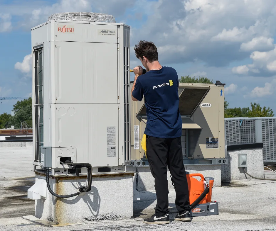 Technicien nettoyant un climatiseur mural à Montréal avec un équipement spécialisé
