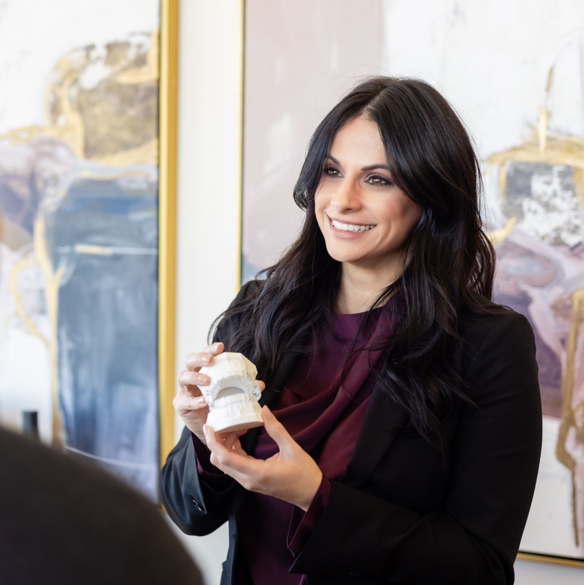 Tiffini Stratton, DDS showing a patient at Lucid a custom-fit mouth appliance