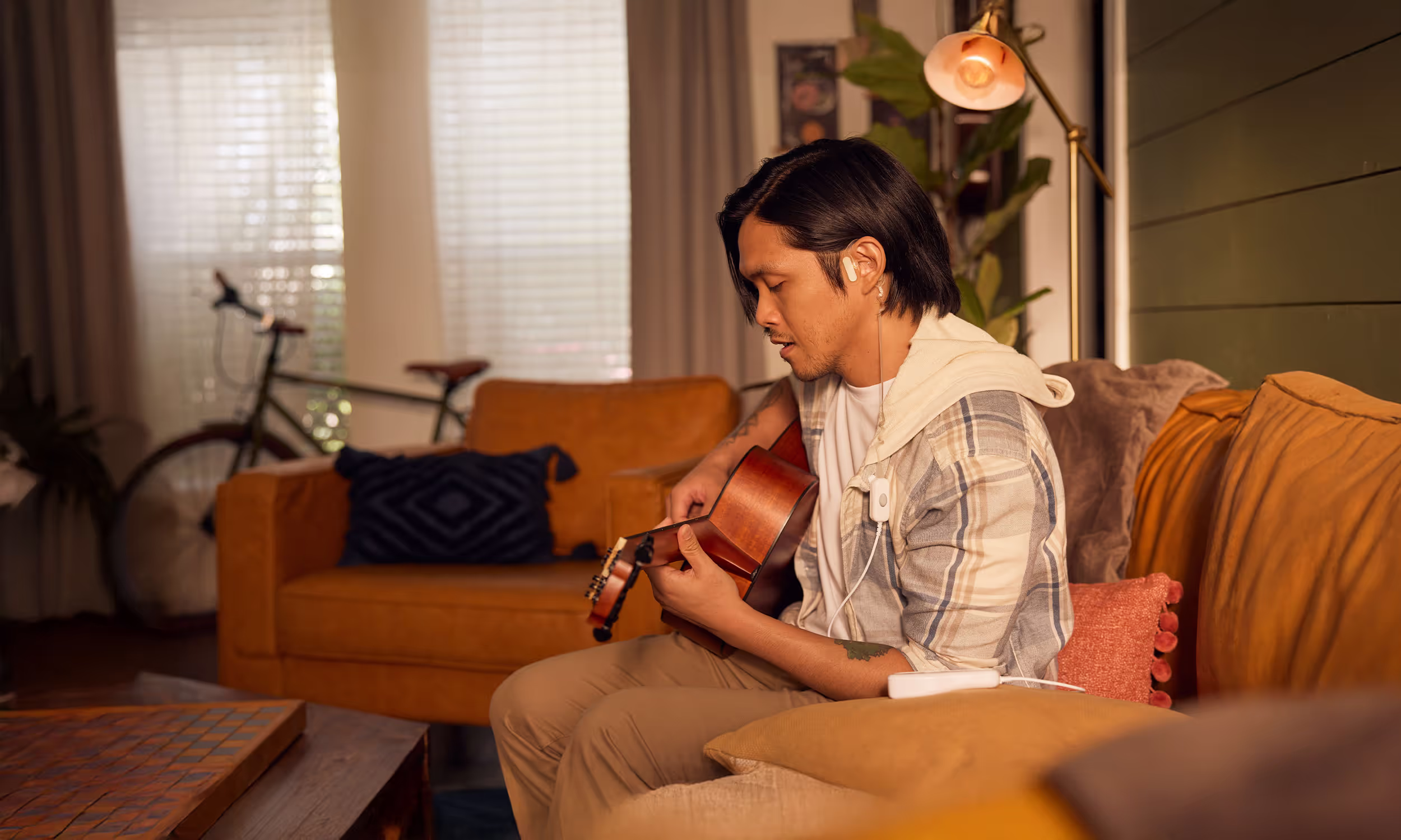 Man playing guitar while using Spark Biomedical Sparrow Ascent
