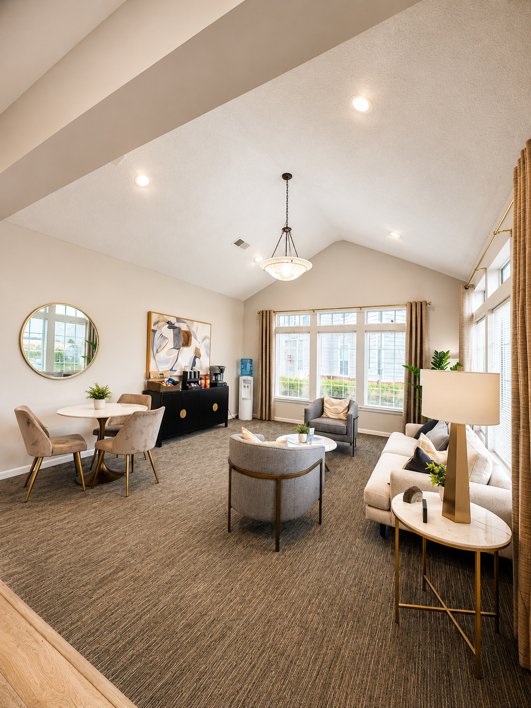The office with seating area featuring table and chairs, sofas, and coffee bar