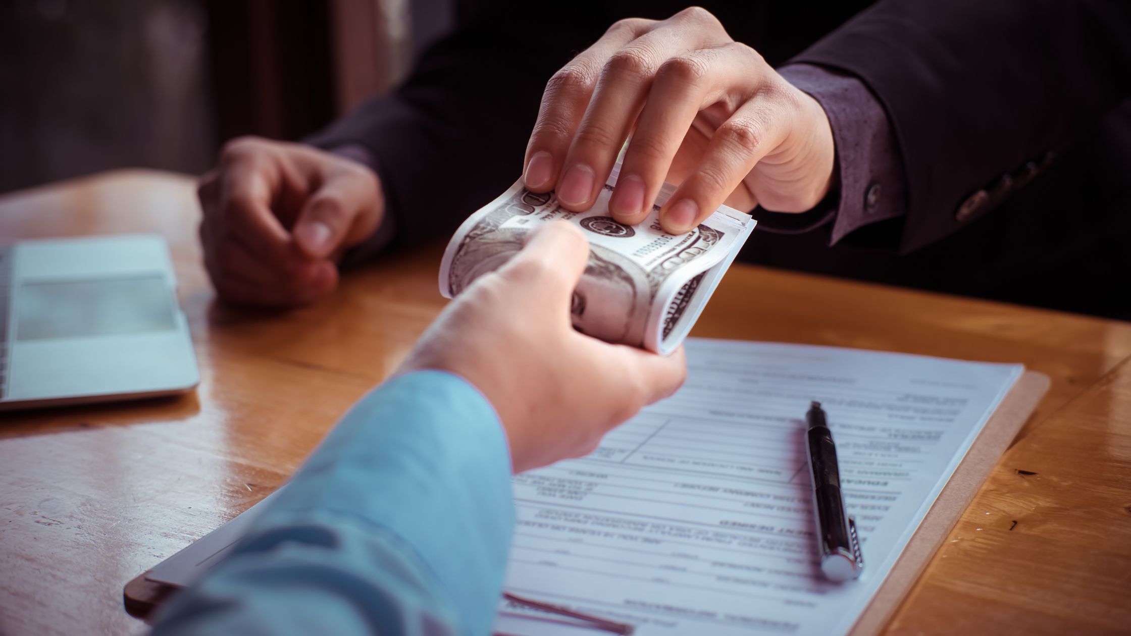 Someone giving money in a get rich quick scheme