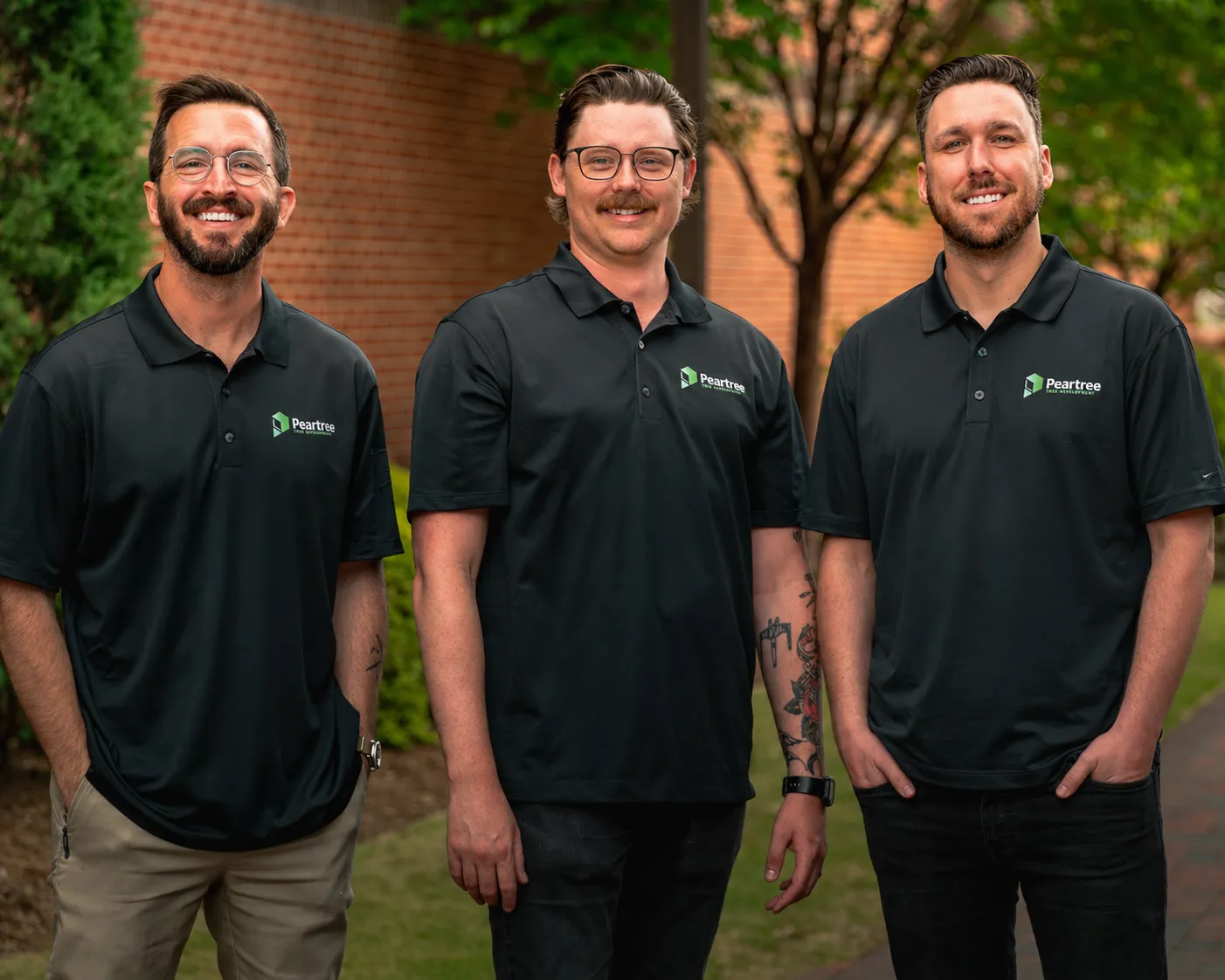A group photo of the founders of Peartree Web Development - Clinton Brothers, Michael Fenwick, and Devin Trulin, standing together