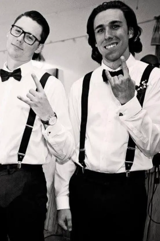 Old photo of two of the founders of Peartree at a wedding, posing together.