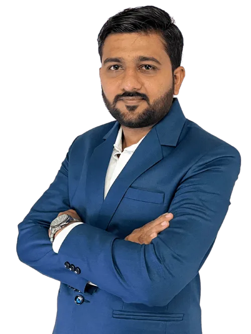 A man in a blue suit with his arms crossed.