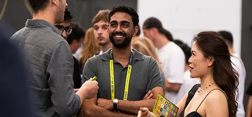 A group of people standing around each other.