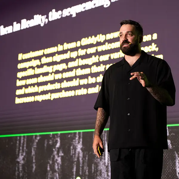 A man standing in front of a projection screen.
