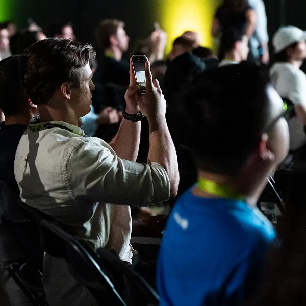 A man taking a picture of a crowd of people.