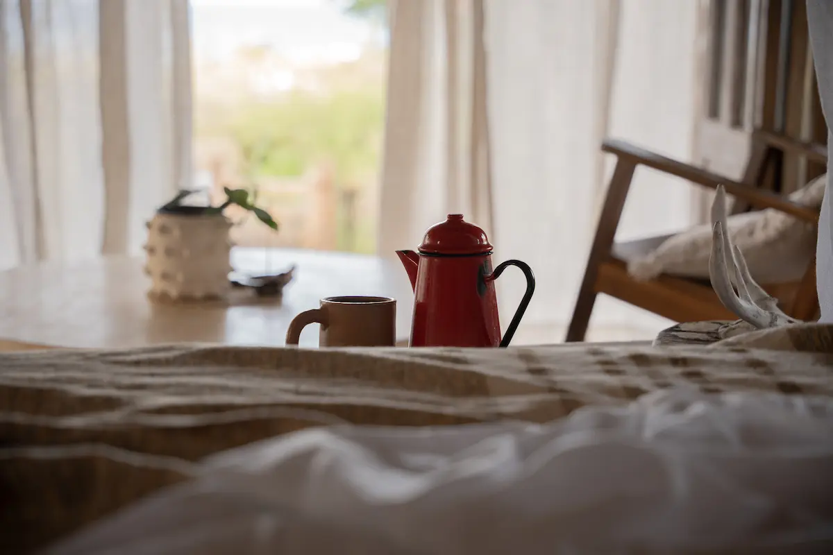 A coffee pot and mug in the foreground.