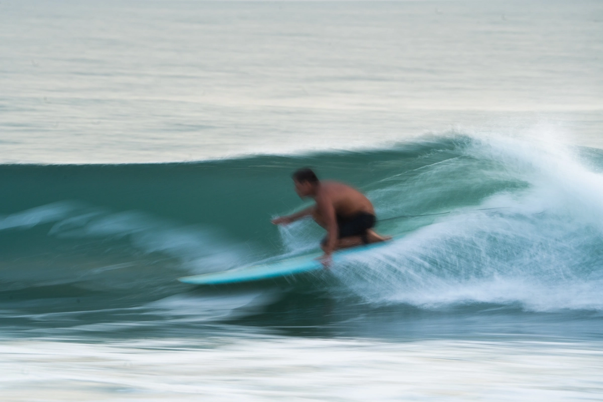 Surfer gliding wave.