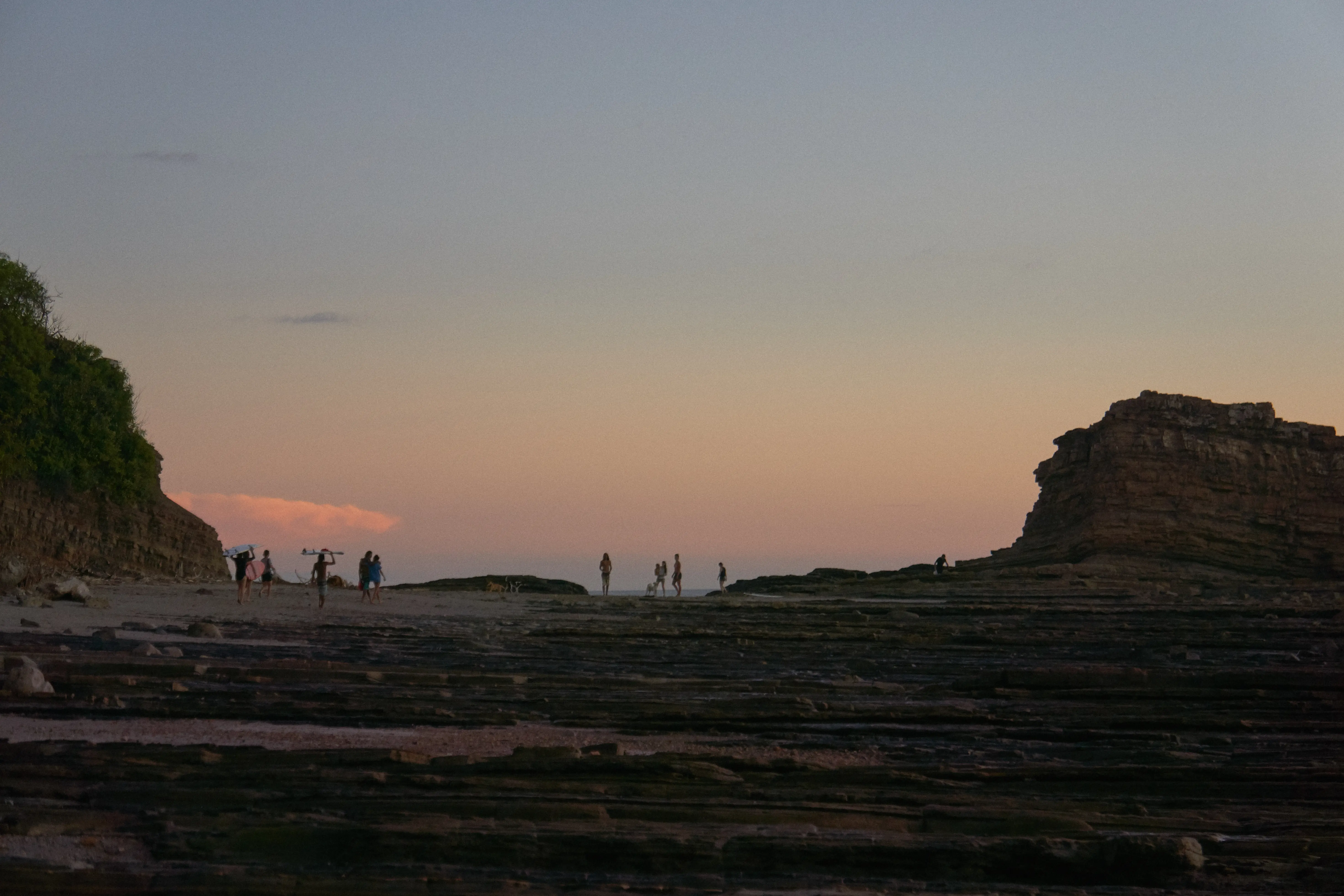 Surfers walking home on Magnific rock at Sardina beach Popoyo Nicaragua