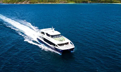 Cat Cocos ferry speeding across the turquoise waters of the Seychelles, offering a fast and scenic transfer between Mahé, Praslin, and La Digue with SeyFerry.