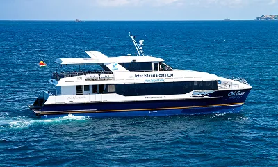 Side view of a Cat Cocos high-speed ferry operated by Inter Island Boats Ltd, sailing between Mahé, Praslin, and La Digue in Seychelles with SeyFerry.