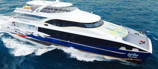 Large Cat Cocos high-speed ferry sailing through open ocean with multiple decks and a sleek, modern design.