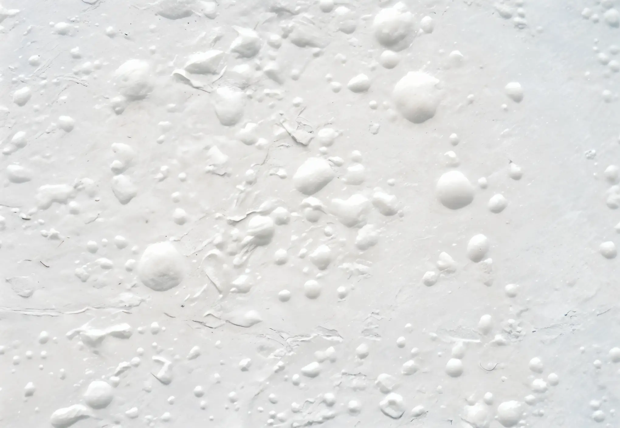 an ultra-realistic photo of bubbling paint and peeling wallpaper near a window in a home
