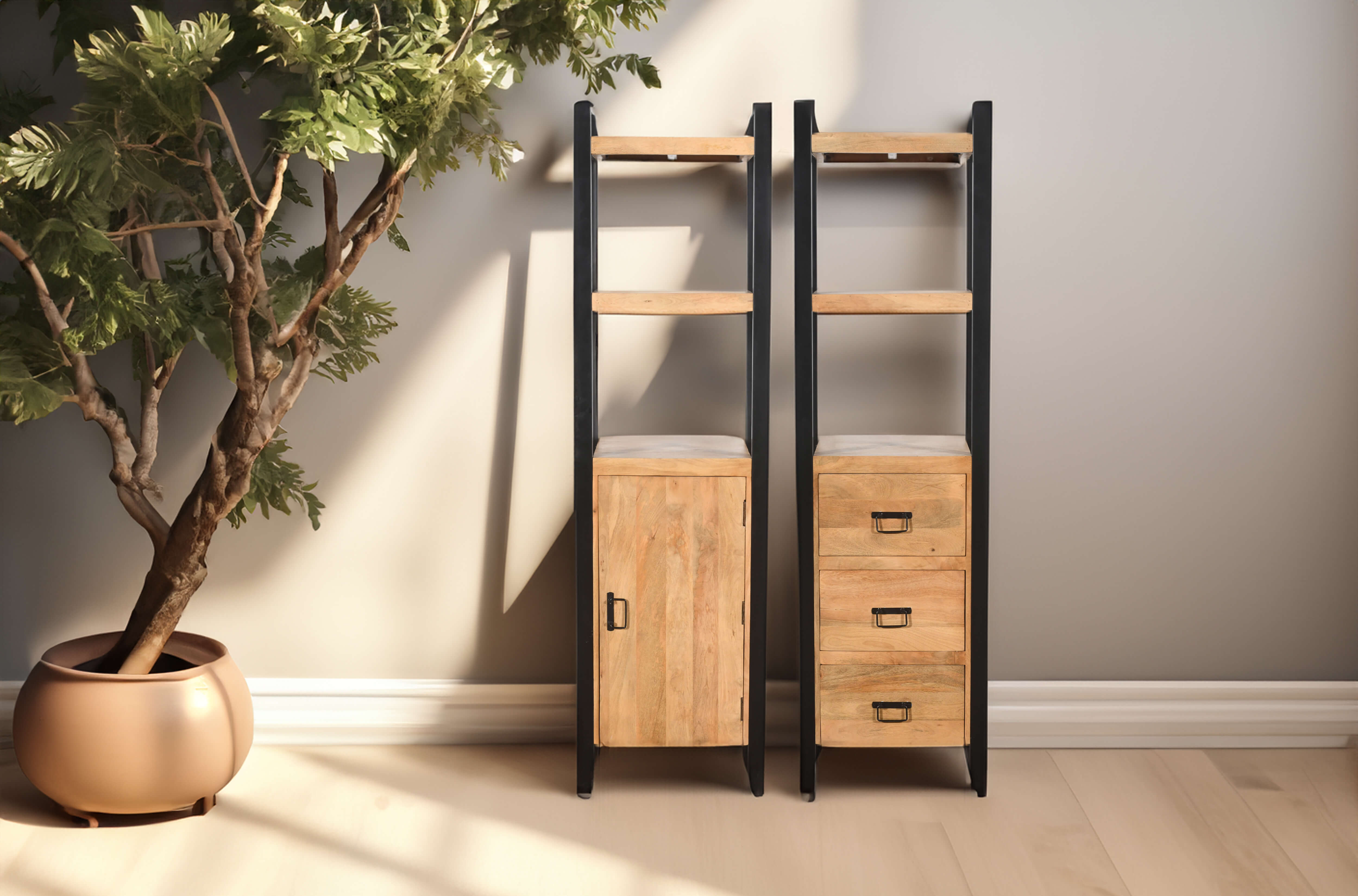 Two tall, narrow shelving units with black metal frames and natural wood shelves, one featuring a cabinet and the other with three drawers, placed beside a potted indoor tree in a sunlit room with light wooden flooring.
