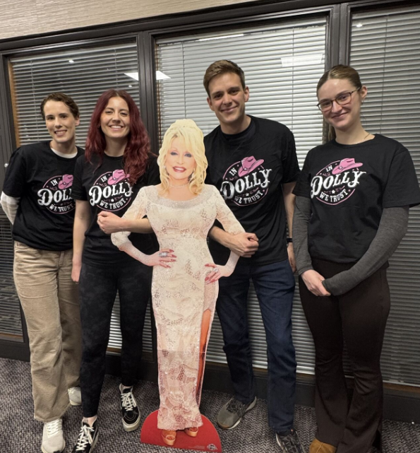 Lucent's advisers wearing Dolly Parton t-shirts and standing with a cardboard cut-out of her