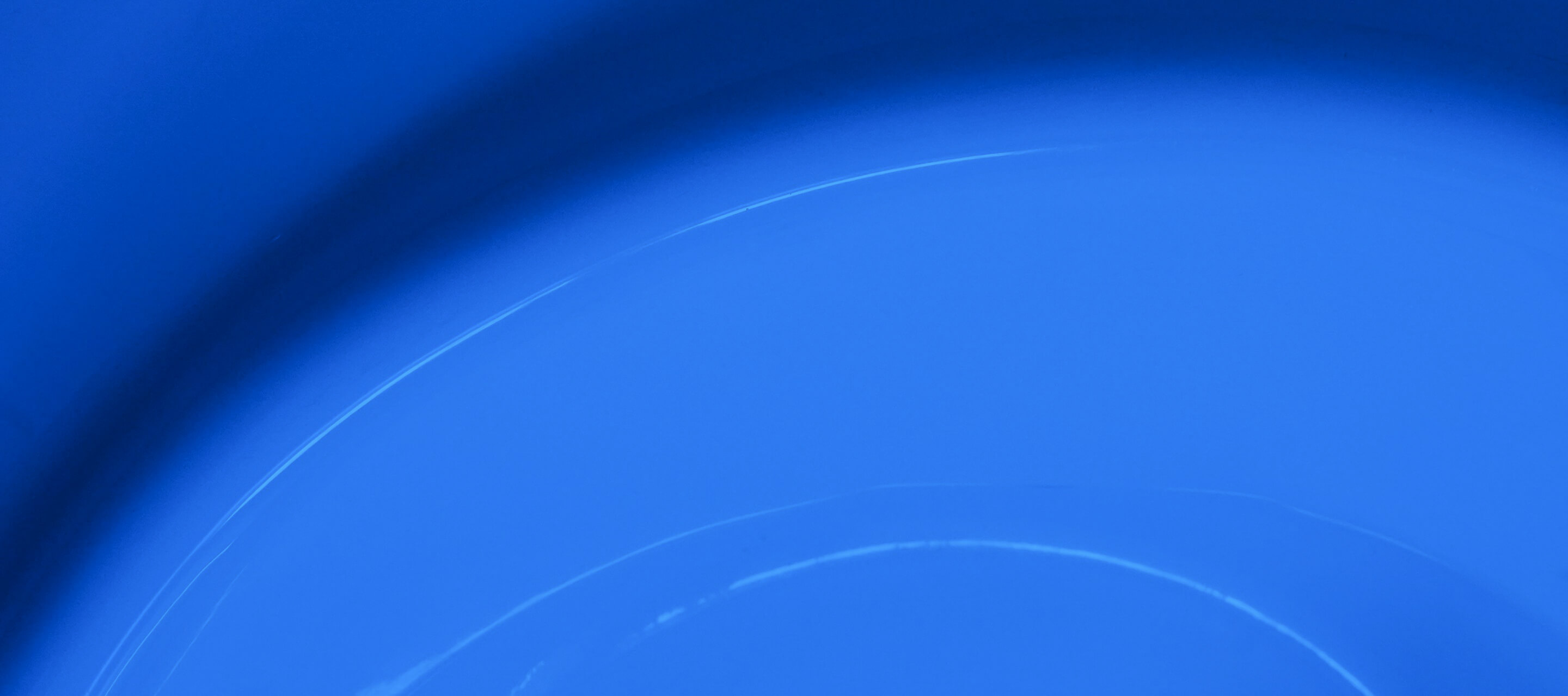 Smooth circular blue gradient texture with subtle light reflections symbolizing calmness and balance.
